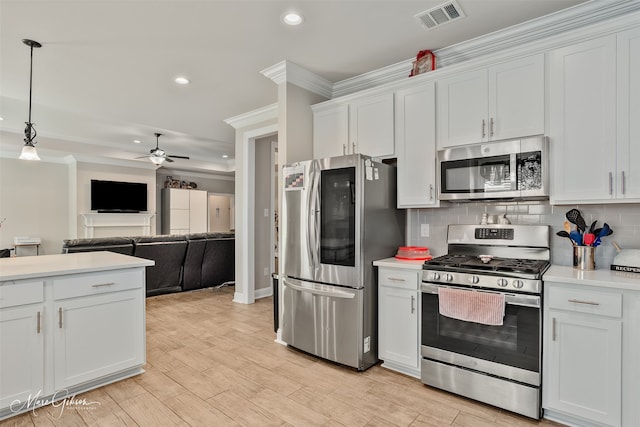 kitchen with light countertops, appliances with stainless steel finishes, visible vents, and tasteful backsplash