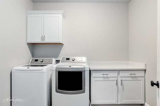 laundry area featuring washing machine and dryer and cabinet space