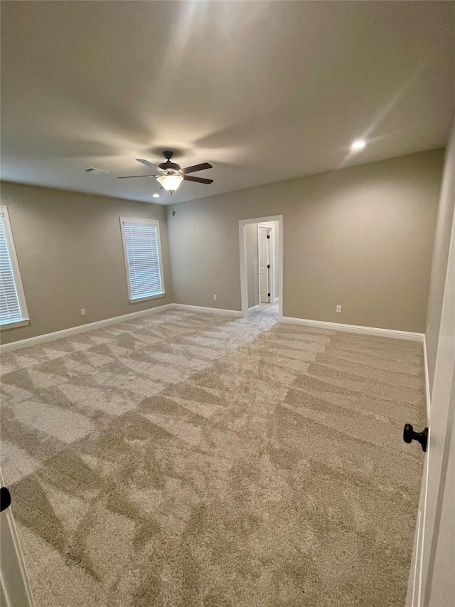 unfurnished room with recessed lighting, light carpet, ceiling fan, and baseboards