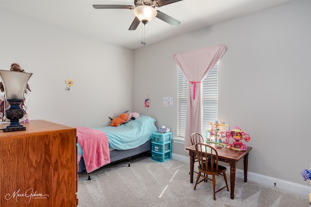 bedroom featuring light carpet, baseboards, and a ceiling fan