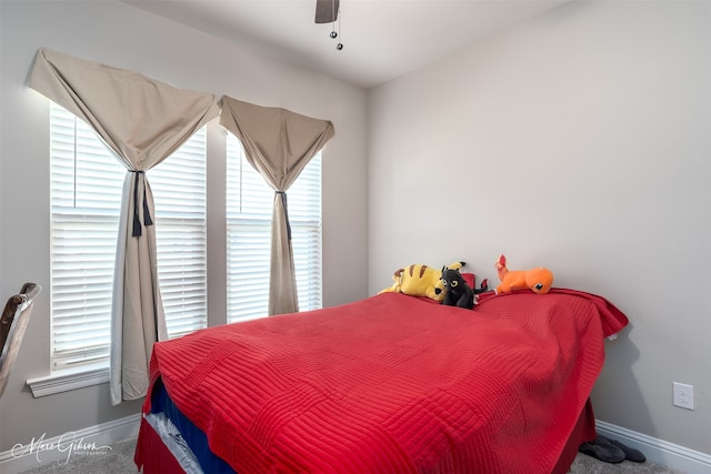 bedroom with a ceiling fan and baseboards