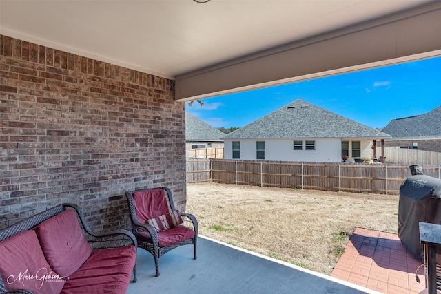 view of patio / terrace with area for grilling and fence