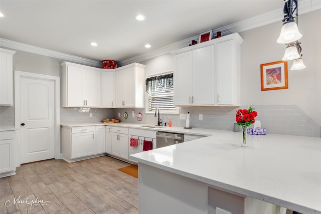 kitchen with crown molding, white cabinetry, and dishwasher