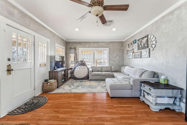 living room featuring crown molding and light wood-style floors