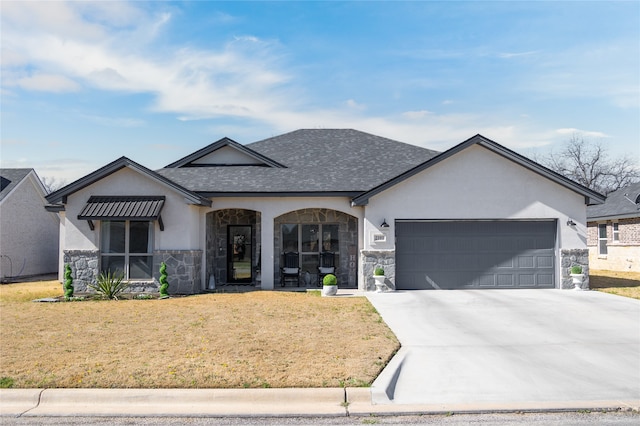 view of front of home with driveway, stone siding, an attached garage, a front lawn, and stucco siding