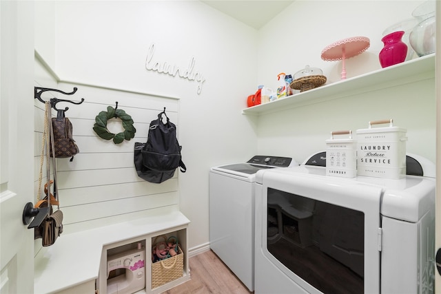 laundry area featuring laundry area, light wood-style flooring, and washer and dryer