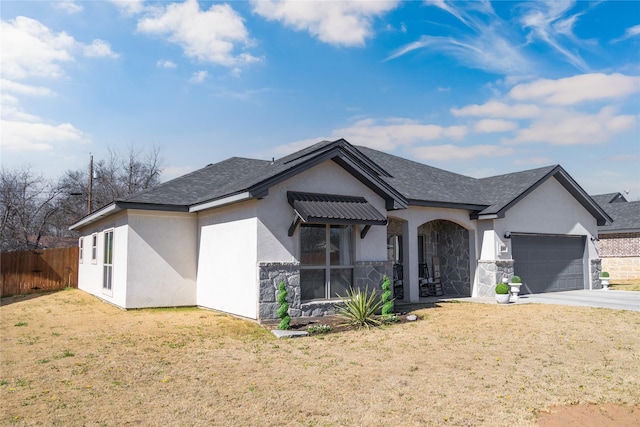 ranch-style house featuring a garage, fence, stone siding, stucco siding, and a front yard