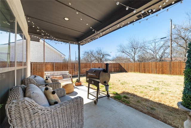 view of patio / terrace featuring grilling area, a fenced backyard, and an outdoor living space