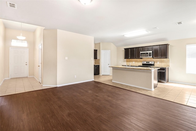 302 Triple Crown Ln, Ponder, TX 76259 - kitchen with light tile patterned floors, stainless steel appliances, tasteful backsplash, and visible vents