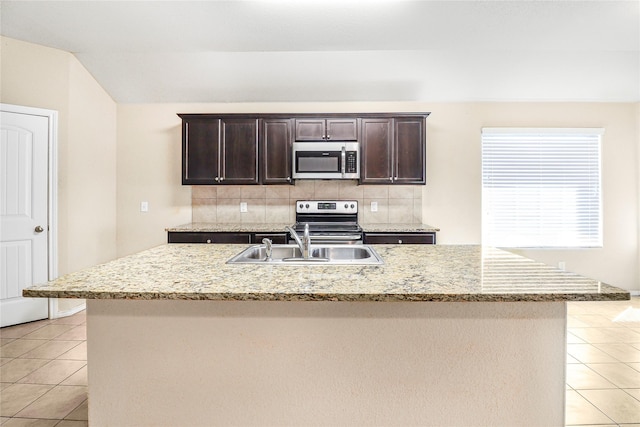 302 Triple Crown Ln, Ponder, TX 76259 - kitchen featuring light tile patterned floors, a kitchen island with sink, stainless steel appliances, and decorative backsplash