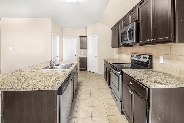 302 Triple Crown Ln, Ponder, TX 76259 - kitchen featuring stainless steel appliances, a sink, dark brown cabinetry, and tasteful backsplash