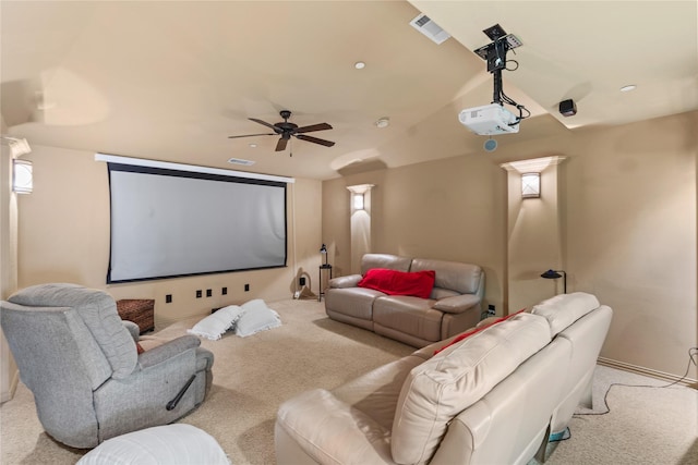 cinema room with a ceiling fan, lofted ceiling, visible vents, and carpet flooring