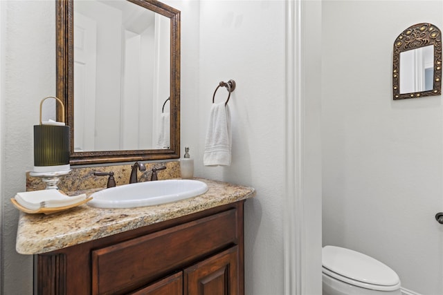 bathroom with toilet and vanity