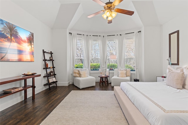 bedroom with a ceiling fan, baseboards, and dark wood-type flooring