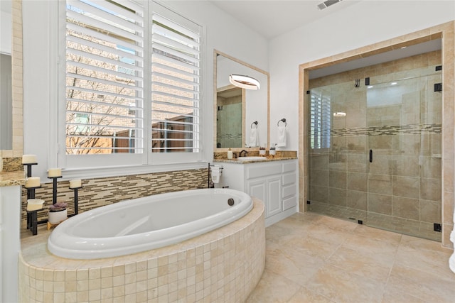 full bathroom featuring visible vents, a shower stall, vanity, a bath, and tile patterned floors