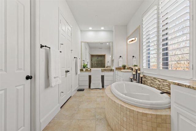 bathroom featuring tile patterned floors, recessed lighting, a bath, and vanity