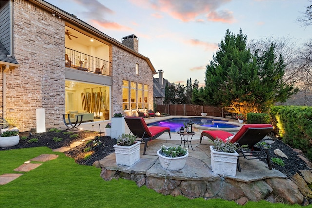 view of patio / terrace featuring a fenced in pool, a fenced backyard, and a balcony