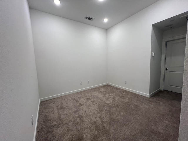 spare room featuring recessed lighting, carpet flooring, visible vents, and baseboards