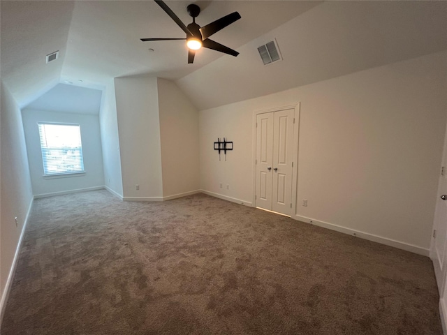 bonus room with carpet floors, baseboards, visible vents, and vaulted ceiling