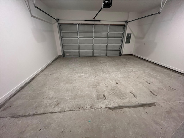 garage featuring baseboards, electric panel, and a garage door opener