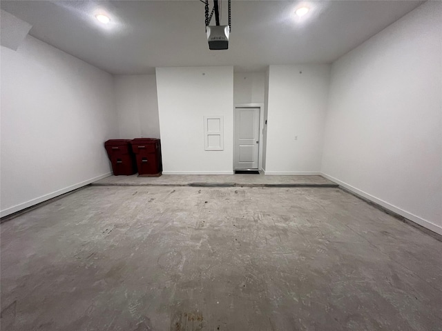 garage with baseboards and a garage door opener