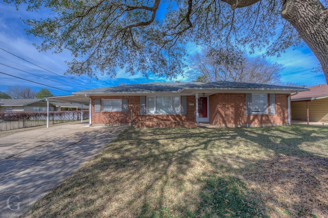 ranch-style house featuring driveway, an attached carport, a front lawn, and brick siding