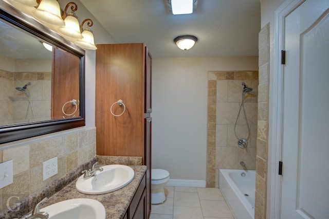 full bathroom featuring double vanity, a sink, toilet, and tile patterned floors