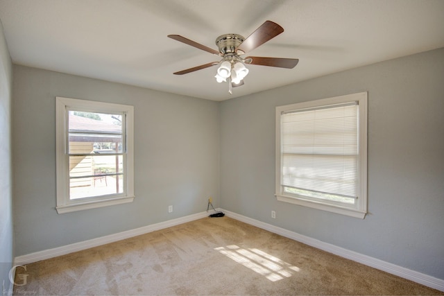 unfurnished room with ceiling fan, baseboards, and light colored carpet