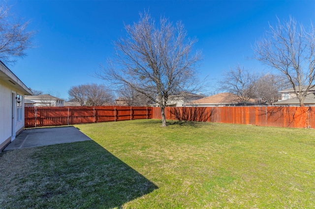 view of yard featuring a patio area and a fenced backyard