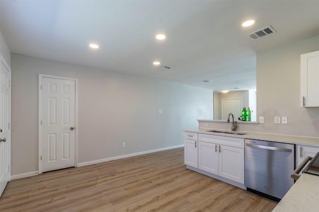 kitchen featuring light wood-style flooring, a sink, visible vents, white cabinetry, and dishwasher