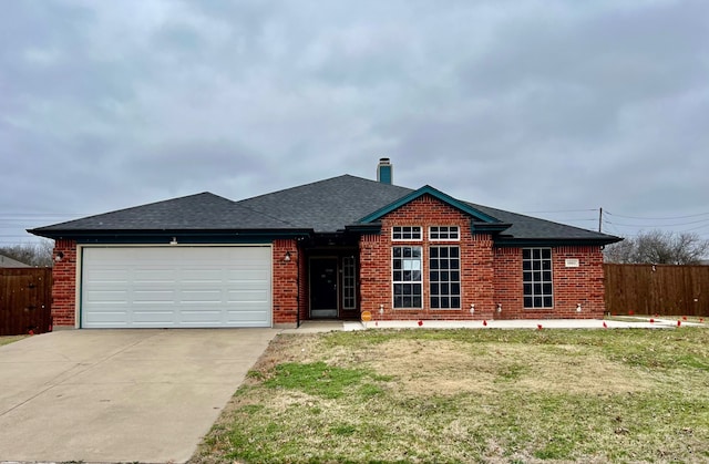 view of front of property with a shingled roof, brick siding, fence, and an attached garage