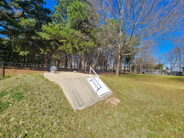 view of storm shelter with fence and a lawn