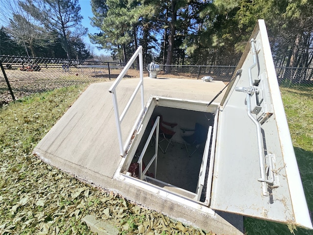 view of storm shelter featuring fence