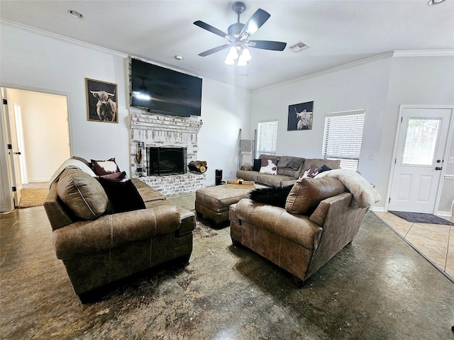 living area with a brick fireplace, ceiling fan, visible vents, and crown molding