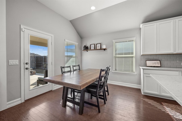 dining area with lofted ceiling, baseboards, and dark wood-style flooring