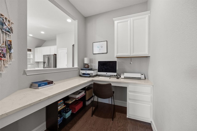 office space featuring baseboards, dark wood-type flooring, built in desk, and recessed lighting