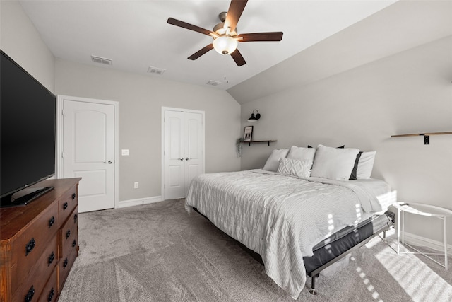 bedroom with light carpet, visible vents, vaulted ceiling, and a closet