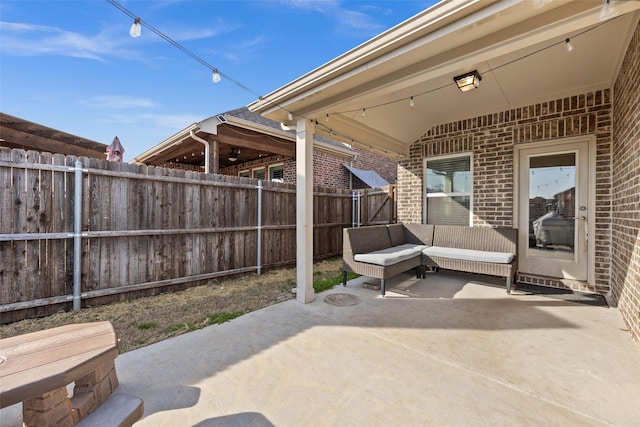 view of patio featuring a fenced backyard, ceiling fan, and outdoor lounge area