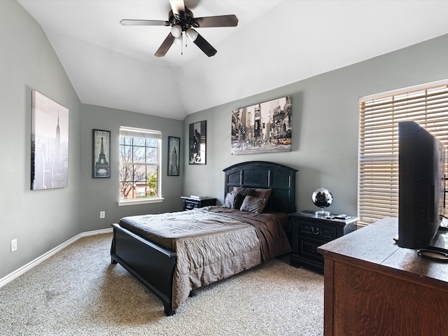 bedroom featuring light carpet, ceiling fan, baseboards, and vaulted ceiling