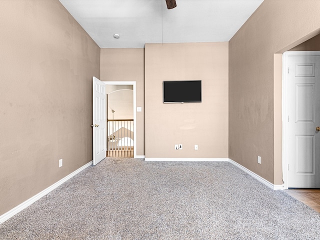 unfurnished bedroom with carpet flooring, ceiling fan, and baseboards