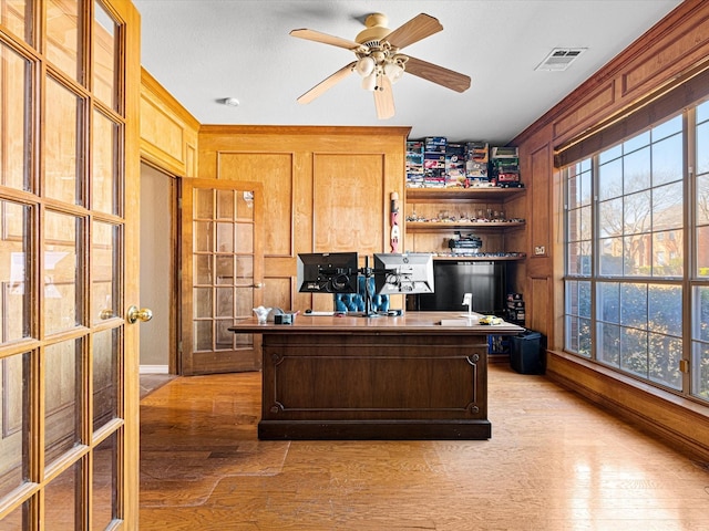 office area featuring light wood finished floors, plenty of natural light, and visible vents