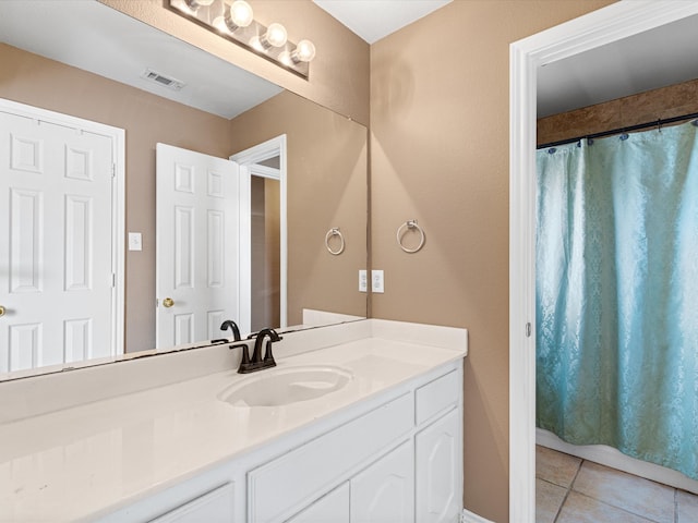 full bathroom featuring vanity, tile patterned flooring, visible vents, and a shower with curtain