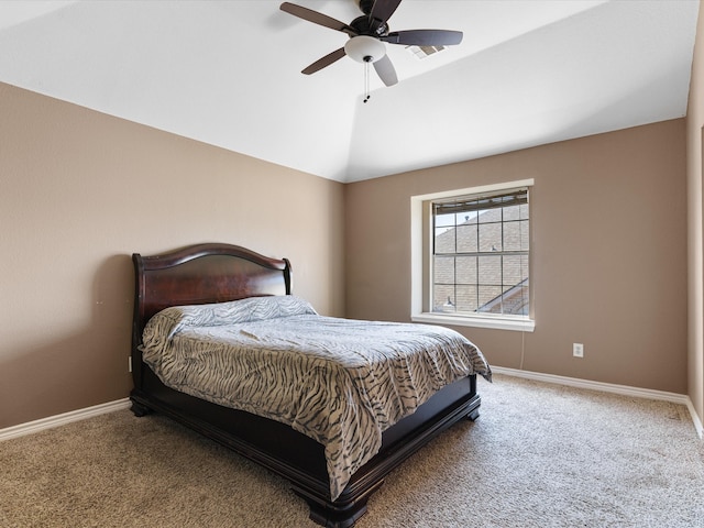 carpeted bedroom with vaulted ceiling, baseboards, and ceiling fan