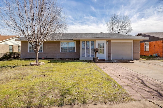 single story home featuring a front lawn, brick siding, driveway, and an attached garage