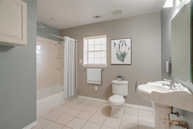 bathroom featuring baseboards, visible vents, toilet, and tile patterned floors