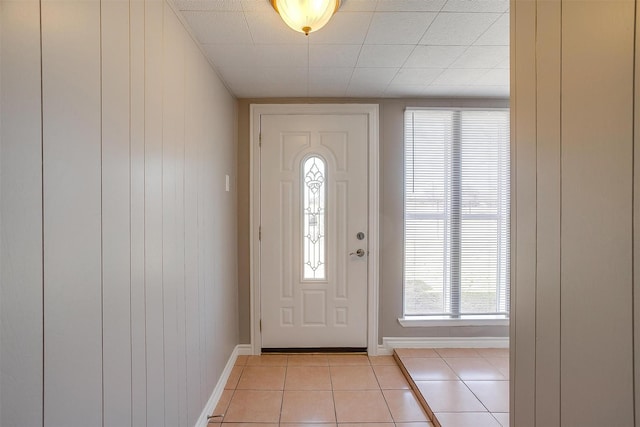 entryway featuring light tile patterned flooring and baseboards