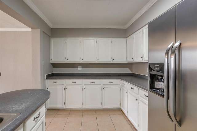 2013 Proctor Dr, Grand Prairie, TX 75051 - kitchen with stainless steel fridge with ice dispenser, dark countertops, white cabinets, light tile patterned flooring, and crown molding