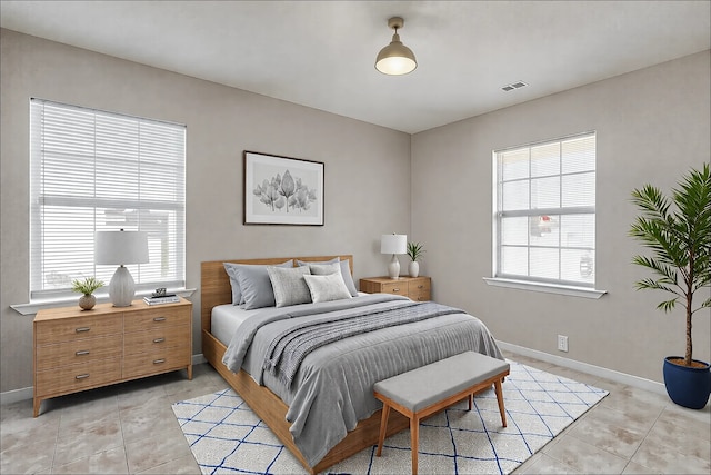 bedroom featuring light tile patterned flooring, visible vents, and baseboards