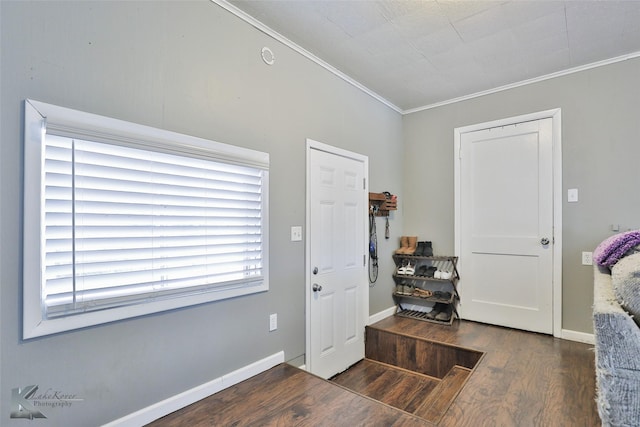 entryway featuring ornamental molding, baseboards, and wood finished floors