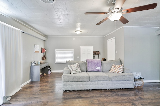 living room with baseboards, wood finished floors, a ceiling fan, and crown molding